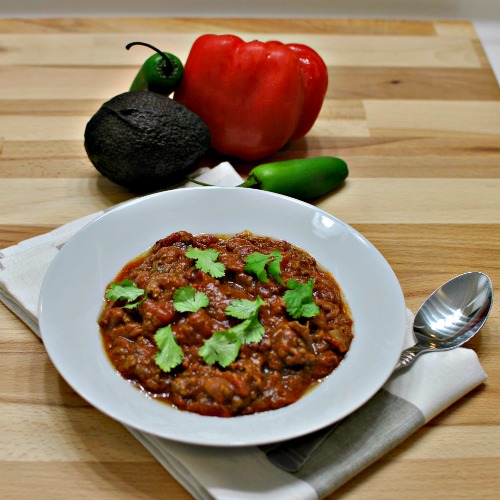 Spicy Saucy Slow Cooker Chili is a healthy recipe to warm you up on these chilly nights. Just throw all the ingredients in your slow cooker for 8 hours. | beckysbestbites.com