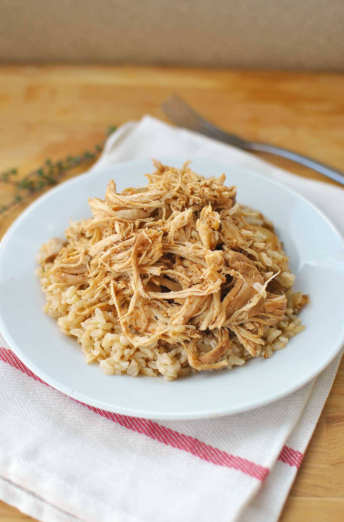 low Cooker Salsa Chicken and Rice might possibly be the easiest meal ever! Boring, weeknight chicken becomes the most popular kid at the table when jazzed up with tangy salsa & spices. Throw some brown rice in your rice cooker and set it to be done when the slow cooker is and dinner is D-O-N-E!!!| Becky's Best Bites