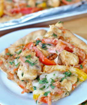 Thai Chicken Pizza with Peanut Sauce is packed with vegetables like red and yellow bell pepper, cilantro and carrots for a unique and healthier pizza night. | beckysbestbites.com