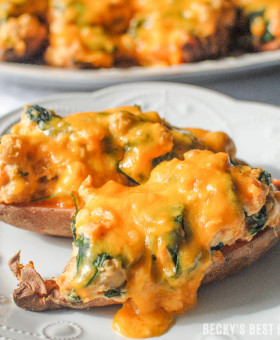 Loaded Sweet Potato Skins will make any New Year's party. Loaded with greek yogurt, cream cheese, chickpeas, spinach and kale and topped with lots of melty cheese, you and your guests will not even realize how nutritious they are!! | beckysbestbites.com