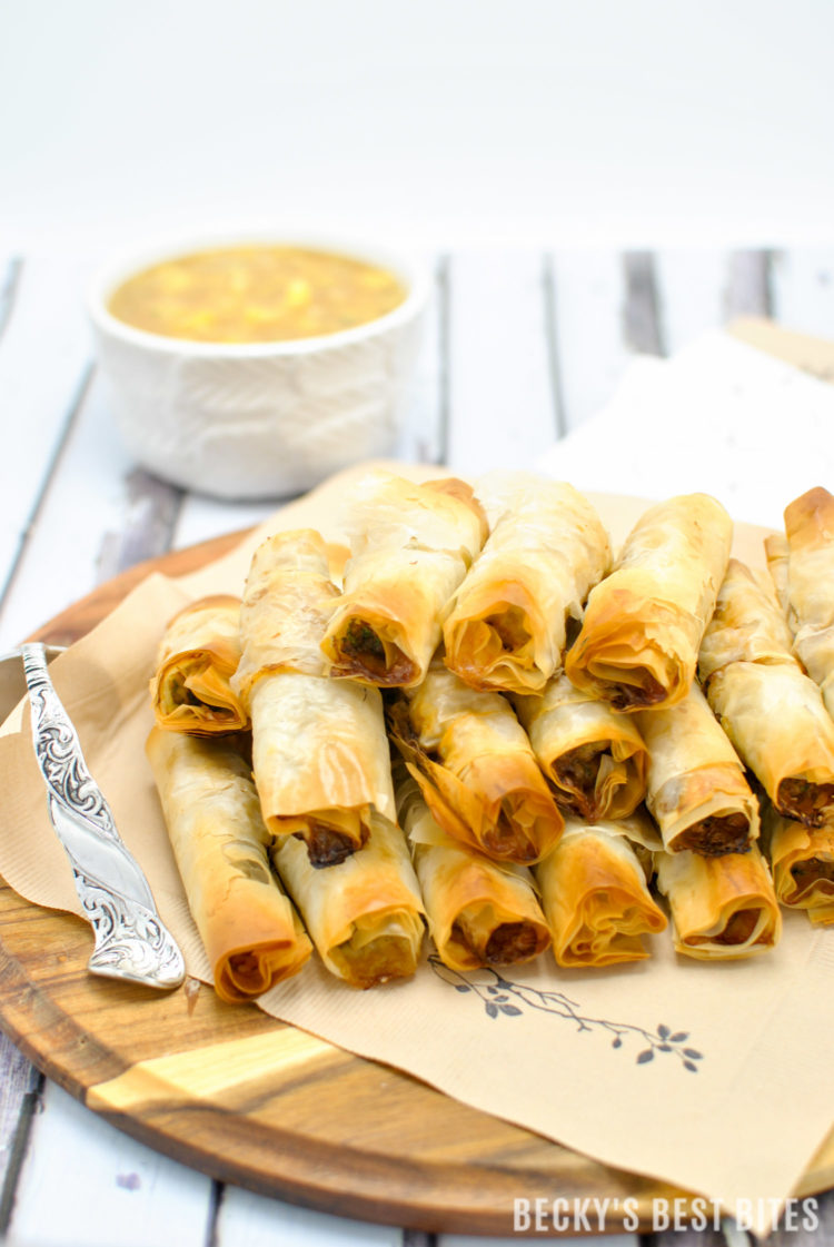 Mini Chicken Cigars with Sweet and Sour Pineapple Dipping Sauce is a tasty and easy appetizer recipe. Entertain in style and impress your guests at your next party with these quick and cute mini bites. #BHGParty | beckysbestbites.com