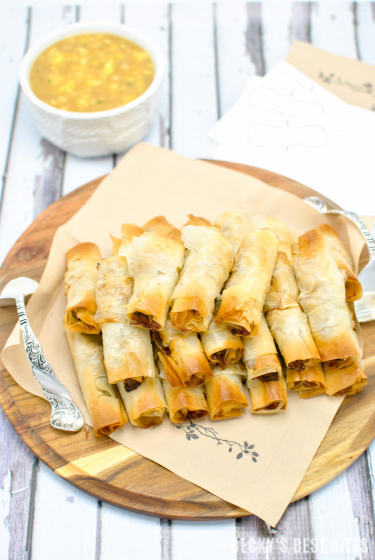 Mini Chicken Cigars with Sweet and Sour Pineapple Dipping Sauce is a tasty and easy appetizer recipe. Entertain in style and impress your guests at your next party with these quick and cute mini bites. #BHGParty | beckysbestbites.com