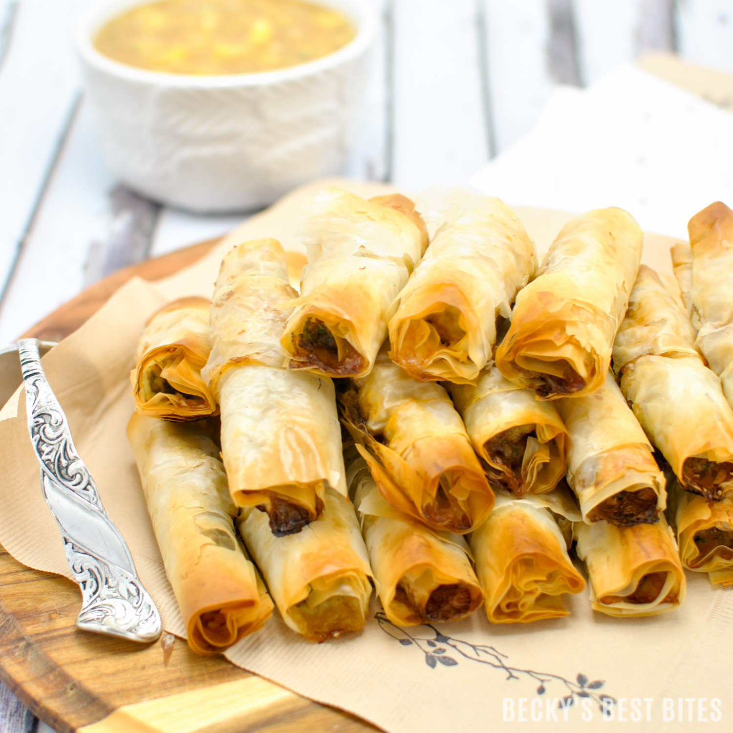 Mini Chicken Cigars with Sweet and Sour Pineapple Dipping Sauce is a tasty and easy appetizer recipe. Entertain in style and impress your guests at your next party with these quick and cute mini bites. #BHGParty | beckysbestbites.com