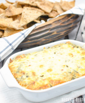 Cheesy Spinach Artichoke Dip with a Kick is the perfect appetizer dip for a game day spread! No mayo, double spinach, four cheeses and just a hint of spice make this ooey gooey yumminess the best spinach artichoke dip I have ever made!! | beckysbestbites.com