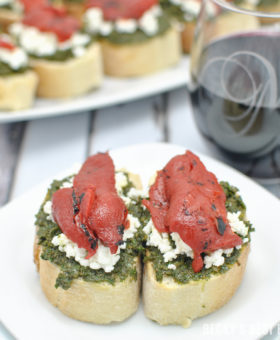 Kale Pesto Goat Cheese Crostini with Roasted Red Pepper + Wines of Garnacha is the perfect pairing for all of your holiday celebrations, parties & gatherings! A quick, easy and festive appetizer and easy drinking wines to enjoy with family and friends. #LoveGarnacha #GarnachaDay #ad