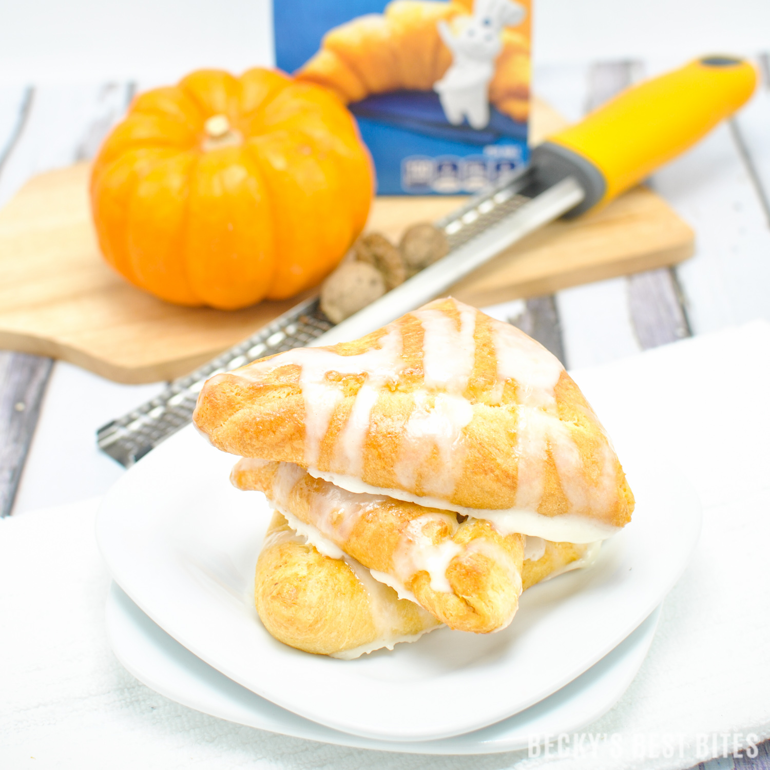 #ad Creamy Baked Pumpkin Pie Empanadas is healthier and easy dessert recipe perfect for Holiday entertaining made with a trusted brand, Pillsbury Crescent Rolls. They are mini kid-approved treats with all the flavors of the fall season and pumpkin pie while saving time to spend with family. #ItsBakingSeason | beckysbestbites.com