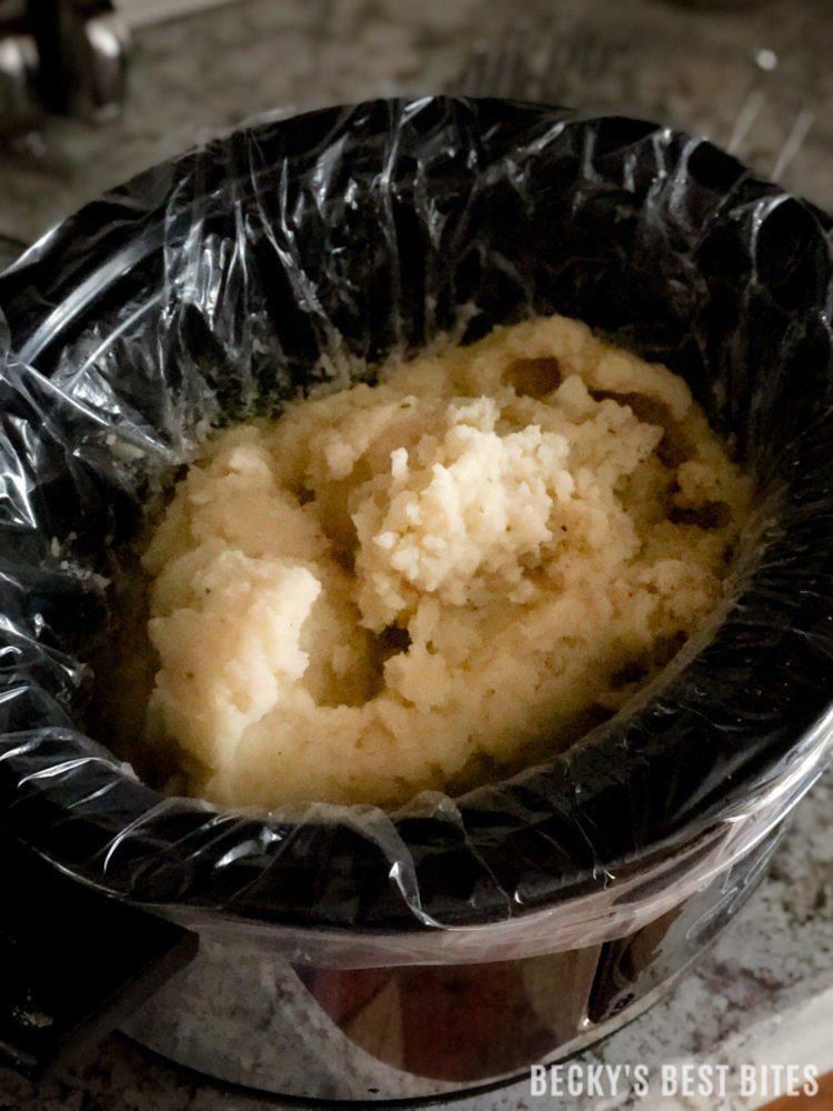 Easy Slow Cooker Mashed Potatoes is the best side dish recipe ever! Great for potluck or holiday dinners! Yummy, make-ahead, portable and easy cleanup...what more could you want? | beckysbestbites.com