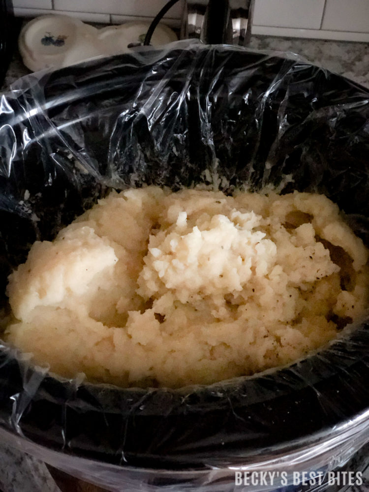 Easy Slow Cooker Mashed Potatoes is the best side dish recipe ever! Great for potluck or holiday dinners! Yummy, make-ahead, portable and easy cleanup...what more could you want? | beckysbestbites.com