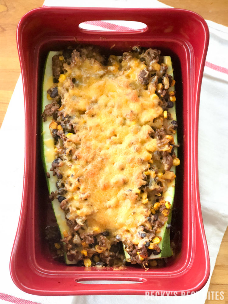 Healthy Zucchini Taco Boats is a healthy and easy dinner recipe that the whole family will love! This favorite summer vegetable is stuffed with taco-flavored filling that also includes corn and black beans for an extra nutritional bonus! | beckysbestbites.com