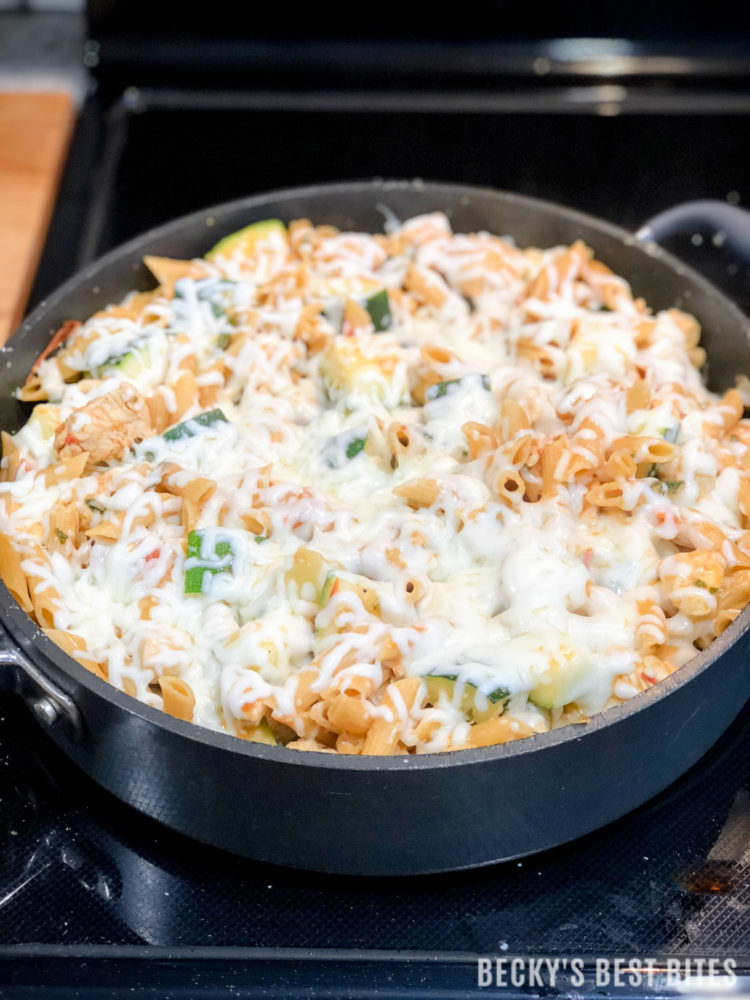 Skillet Chicken Parmesan with Zucchini an easy and healthy recipe that the whole family will love! This one-pan meal combines summer fresh vegetables and herbs with lean, boneless chicken breast & whole wheat pasta and is topped with ooey gooey cheese! | beckysbestbites.com