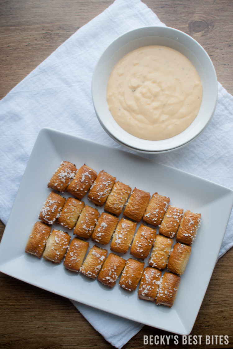 Easy Cheese Sauce is an easy and slimmed-down version of your typical cheese sauce and pairs beautifully with  SUPERPRETZEL® Soft Pretzels! Enjoy them together as appetizers, party treats, after school, game day or an anytime snack!